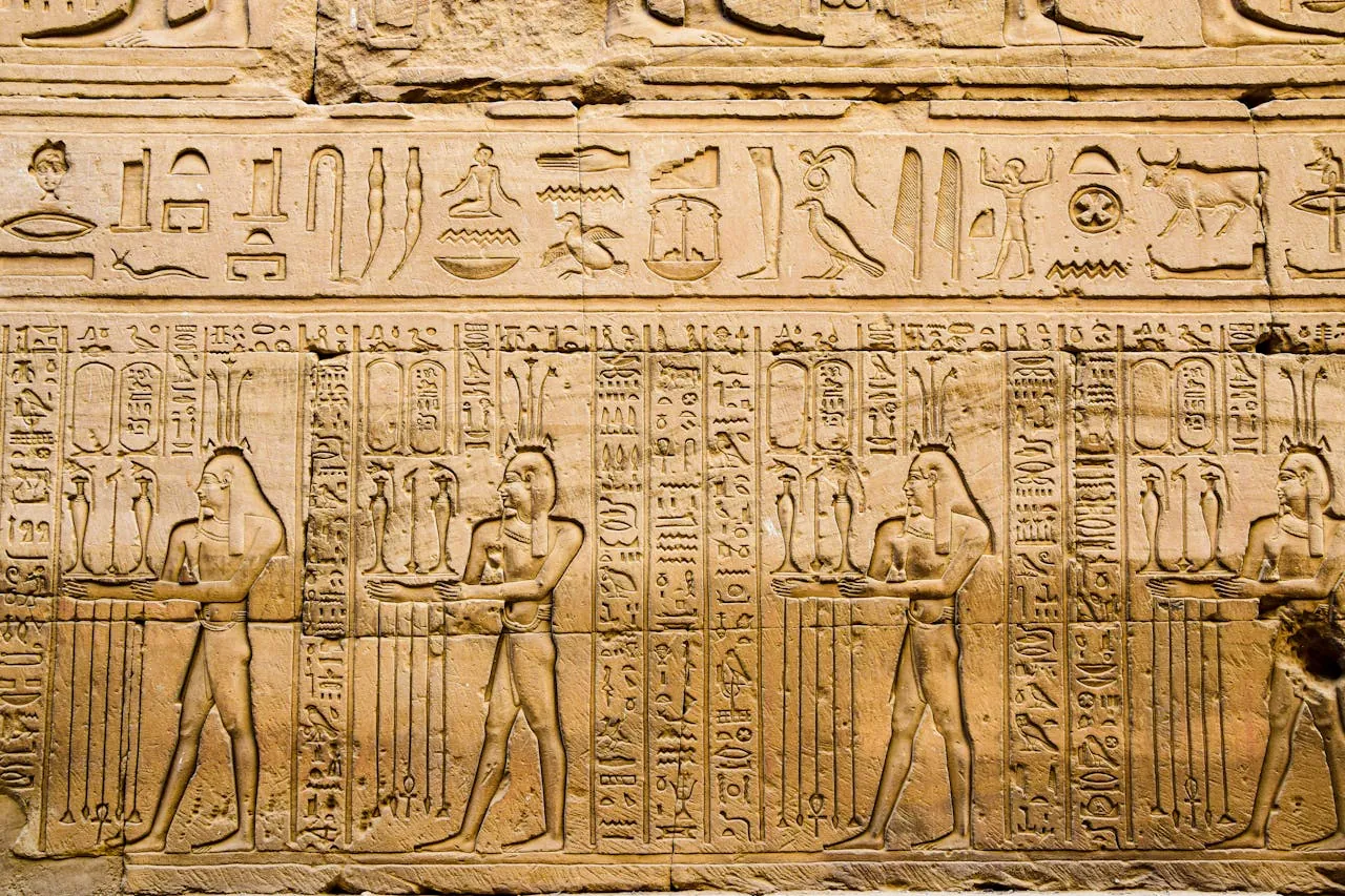 Detailed hieroglyphics and carvings on a wall in Luxor, Egypt, by AXP Photography on Pexels https://www.pexels.com/photo/carved-ancient-wall-with-hieroglyphs-16386716/